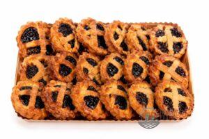 Tray of jam-filled thumbprint cookies with lattice crusts in a wooden box. Disks have golden-brown edges and dark berry centers.